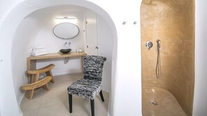 A bathroom with a shower, a sink, a mirror, and a chair. - Executive Villa With Private Outdoor Plunge-pool, Sea Sunset View 4 Guests (Santorini)