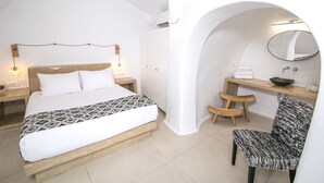 A bedroom with a bed, bedside tables, a chair, a desk, and a mirror. - Executive Villa With Private Outdoor Plunge-pool, Sea Sunset View 4 Guests (Santorini)