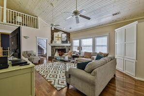 A spacious living room with a fireplace, a staircase, and a ceiling fan. - **NEW LISTING ** ALOFT in Blue Ridge -New listing in Downtown Blue Ridge (Blue Ridge)