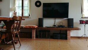 A living room with a TV, speakers, and a drum set. - Intimate little paradise! (Camaiore)