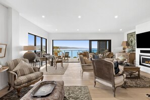 A spacious living room with a large window overlooking a scenic view.