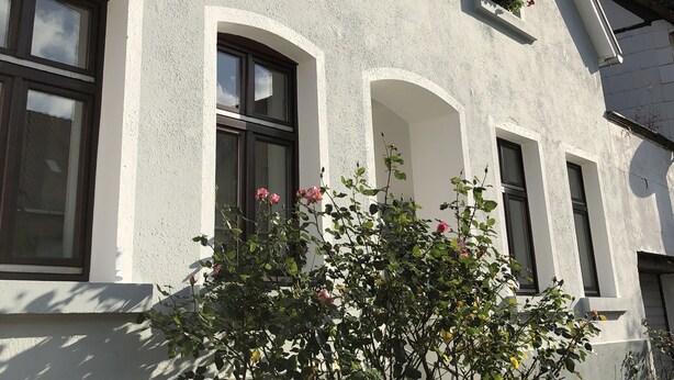 A building with multiple windows and flower boxes.
