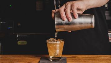 A person pouring a drink into a glass.