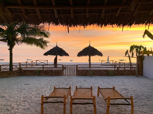 Villa Thamani beachfront and private beach with umbrellas