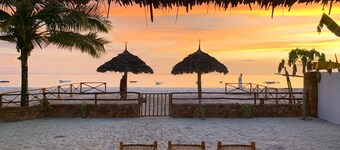 Villa Thamani beachfront and private beach with umbrellas