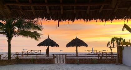 Villa Thamani beachfront and private beach with umbrellas