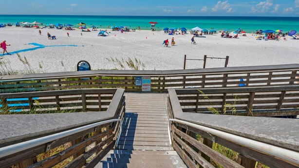 A wooden boardwalk leading to a beach with clear turquoise water and people sunbathing. - Spacious two bedroom, 2 1/2 bath townhome with sleeping loft (Santa Rosa Beach)