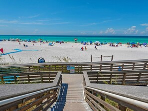 A wooden boardwalk leading to a beach with clear turquoise water and people sunbathing. - Spacious two bedroom, 2 1/2 bath townhome with sleeping loft (Santa Rosa Beach)