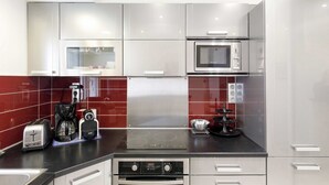 A modern kitchen with stainless steel appliances, a built-in oven, and a stovetop.