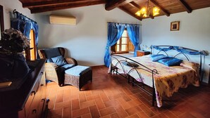 A cozy room with a bed, a chair, a dresser, and a window with curtains. - Detached house in nature suitable for families (2 double bedrooms) and dogs (Camaiore)