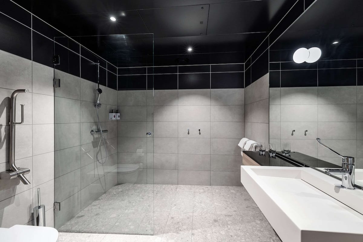 standard double room | bathroom | shower, hair dryer, towels, soap