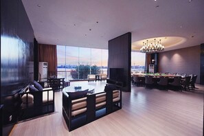 A spacious living area with a large window, a dining table, and a pool table. - Jiuhua Chunshenhu Suzhou (Suzhou)