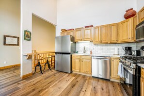 Enjoy cooking in this well-equipped kitchen with a double-door refrigerator, dishwasher, and gas stove.