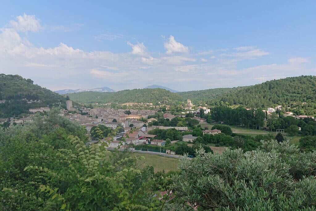 A town nestled in a valley with buildings and greenery.