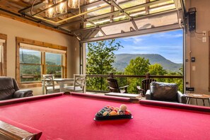 A pool table with balls in a room with a view of mountains. - Moonlit Lodge - Hot Tub, Modern Vibes & Firepit (Sevierville)