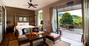 A bedroom with a four-poster bed, a dining table, and a balcony with outdoor furniture. - Taj Chia Kutir, Resort & Spa (Kurseong)