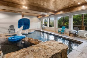 A pool with a basketball hoop, Adirondack chairs, and a wooden ceiling. - Splash 'N Heavenly Views – Indoor Pool, Theater & Mountain Views (Gatlinburg)