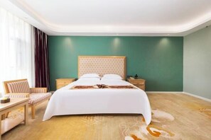 A hotel room with a large bed, bedside tables, a chair, and a view of the outdoors. - Baoshi International Hotel (Antu)