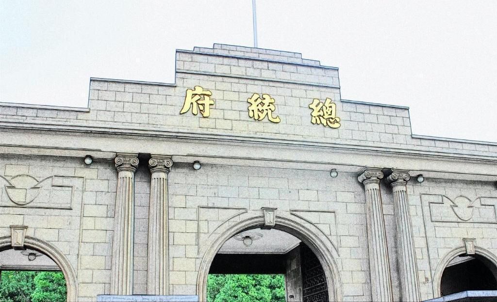 A building with classical architecture, featuring a prominent entrance with two columns and a central archway.