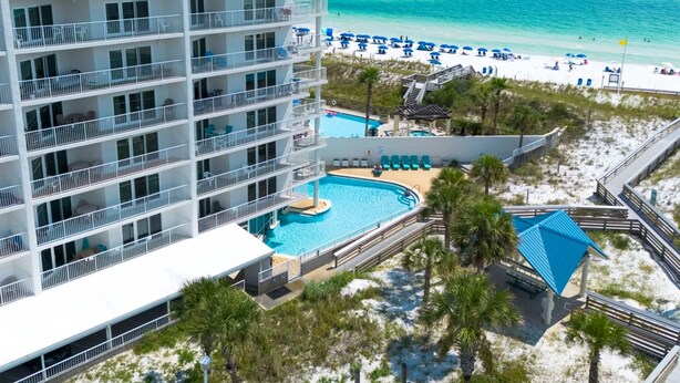 A multi-story hotel with a pool and beach access. - Beachfront Condo, Gulf Views, Sunset Balcony, Okaloosa Island (Fort Walton Beach)