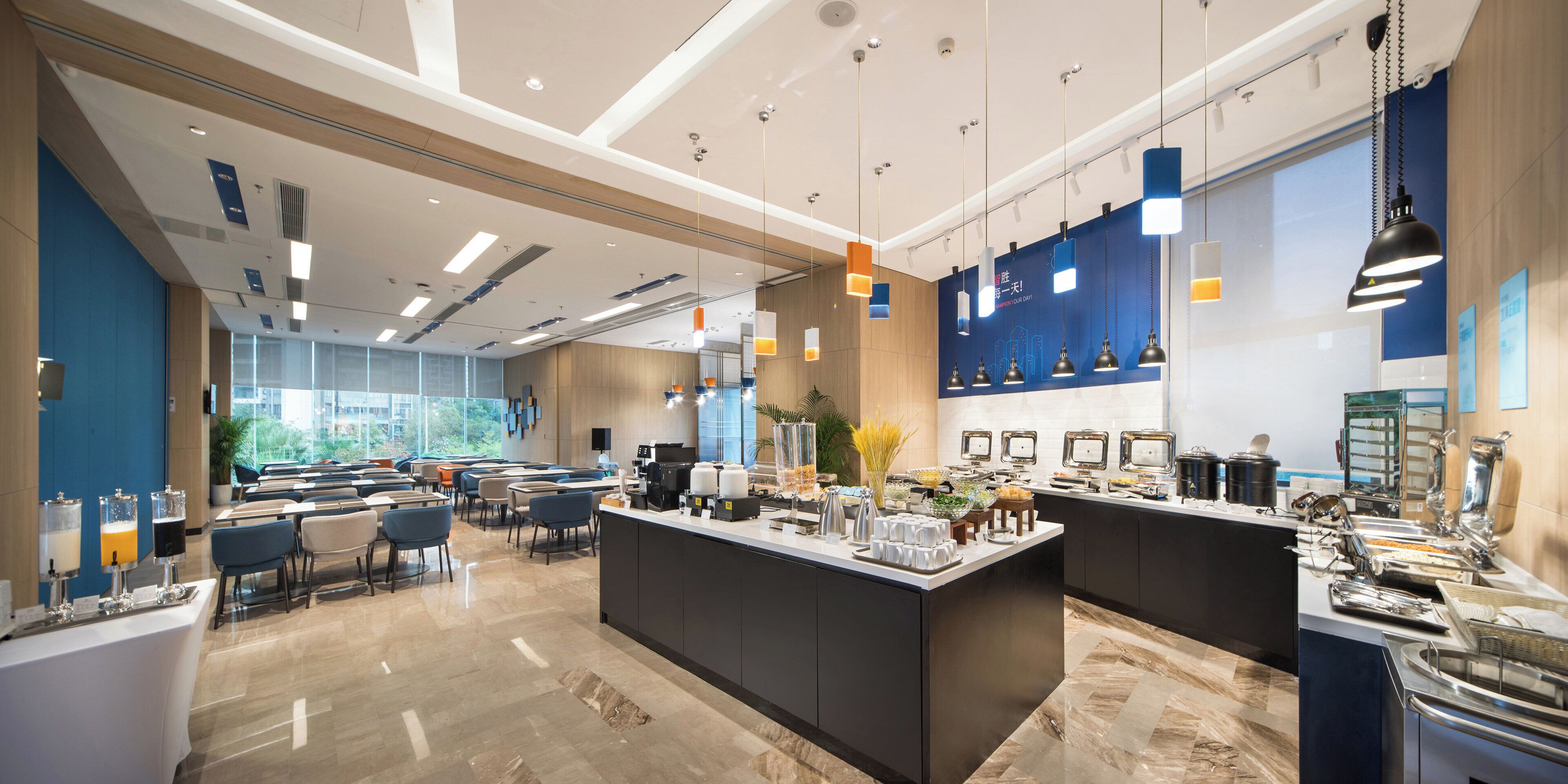 A modern hotel lobby with a reception desk, seating area, and a buffet.