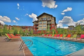 Relax by the large pool surrounded by lounge chairs and enjoy the hotel's scenic views.