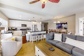 Relax in this open-plan living space with a kitchen, dining area, and comfortable seating.