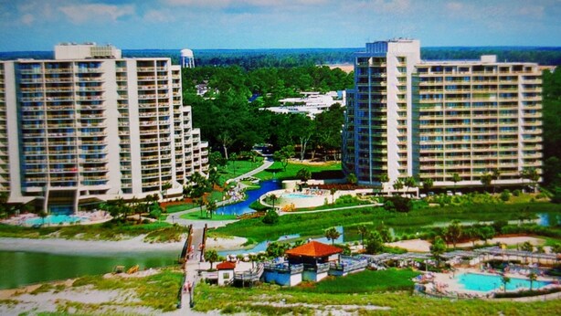 A resort with multiple high-rise buildings, a beach, and a pool area. - Hidden gem in the heart of Ocean Creek (Myrtle Beach)