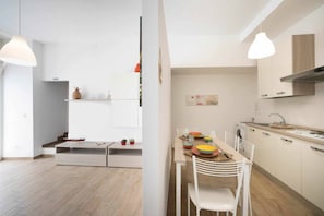 Cozy living space with a dining area for two, kitchenette, and natural light.
