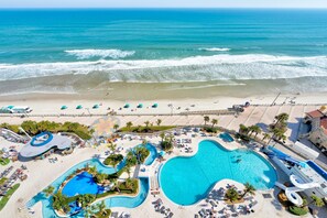 A resort with a large pool, beach, and ocean view. - Oceanfront Balcony! Lazy River, Beach & Boardwalk (Daytone Beach)