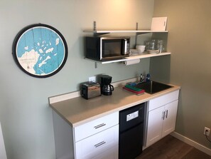 Fridge, microwave, coffee/tea maker, cookware/dishes/utensils