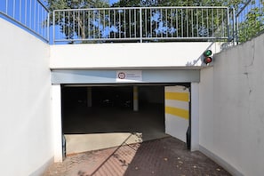 A parking garage entrance with a sign indicating a 2-meter height limit.