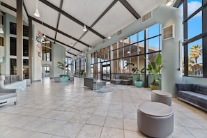 Relax in our spacious lobby with high ceilings, large windows, and comfortable seating areas.