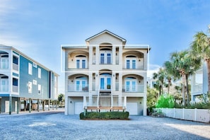 A multi-story hotel with a central courtyard, balconies, and a covered area.