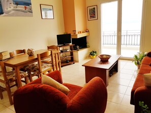 TV, fireplace, DVD player, books -  Sunrise 2 Apartment - Beautifully Located Air Conditioned Apartment Above Beach (Xiropigado)