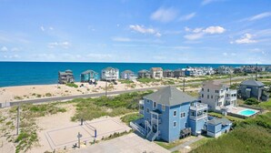 A coastal residential area with houses, a beach, and a road. - Premier Semi-Oceanfront w/ Pool, Hot Tub, Elevator, Theater, Bocce/Putting Court (Rodanthe)