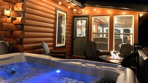 A cozy log cabin with a hot tub, string lights, and a fireplace. - Cub Cabin on Massanutten Resort- Fully Renovated Log Cabin- Hot Tub & Fire Pit (Massanutten)