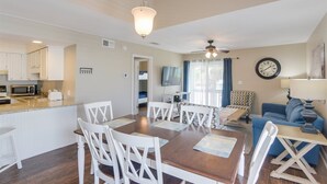 A compact living space with a kitchen, dining area, and seating area. - Gulf view condo - Now Incl. Beach Service  (Miramar Beach)