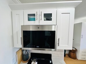 Microwave, coffee/tea maker, toaster, cookware/dishes/utensils