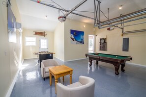 Relax and have fun in this spacious room with a pool table, foosball table, and cozy seating area.