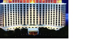 A large, multi-story hotel with a prominent marquee sign at the top. - Beach View Cottage Perfect for Family & Friends! (Gulfport)