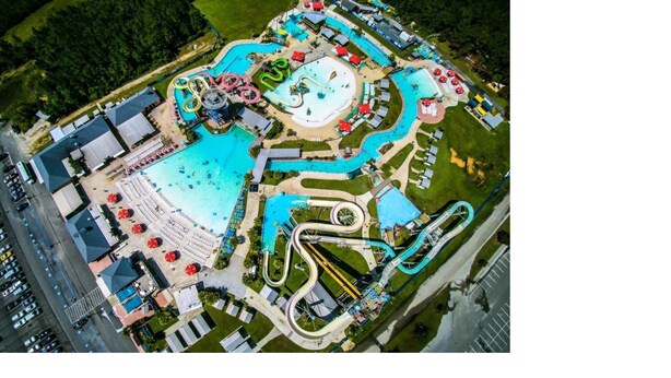 An aerial view of a water park with multiple slides and pools. - Beach View Cottage Perfect for Family & Friends! (Gulfport)