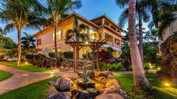 A resort with a large building, a water feature, and palm trees. - Poipu Kai B111: Lovely Gardenview Villa w/Shared Pool, Spa & AC, Near Beaches (Koloa)