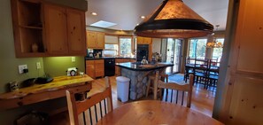 Enjoy meals in the open-plan kitchen and dining area with a central island, oven, and sink.