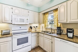 Enjoy cooking in this well-equipped kitchen with a double oven, microwave, and dishwasher.
