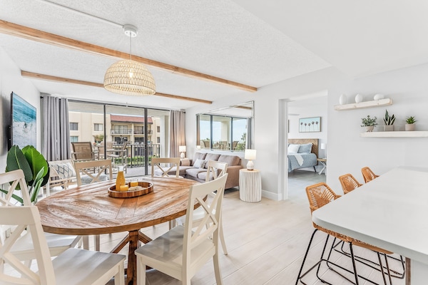 Elegant dining area with a rustic-modern design, woven light fixture, and natural wood accents.