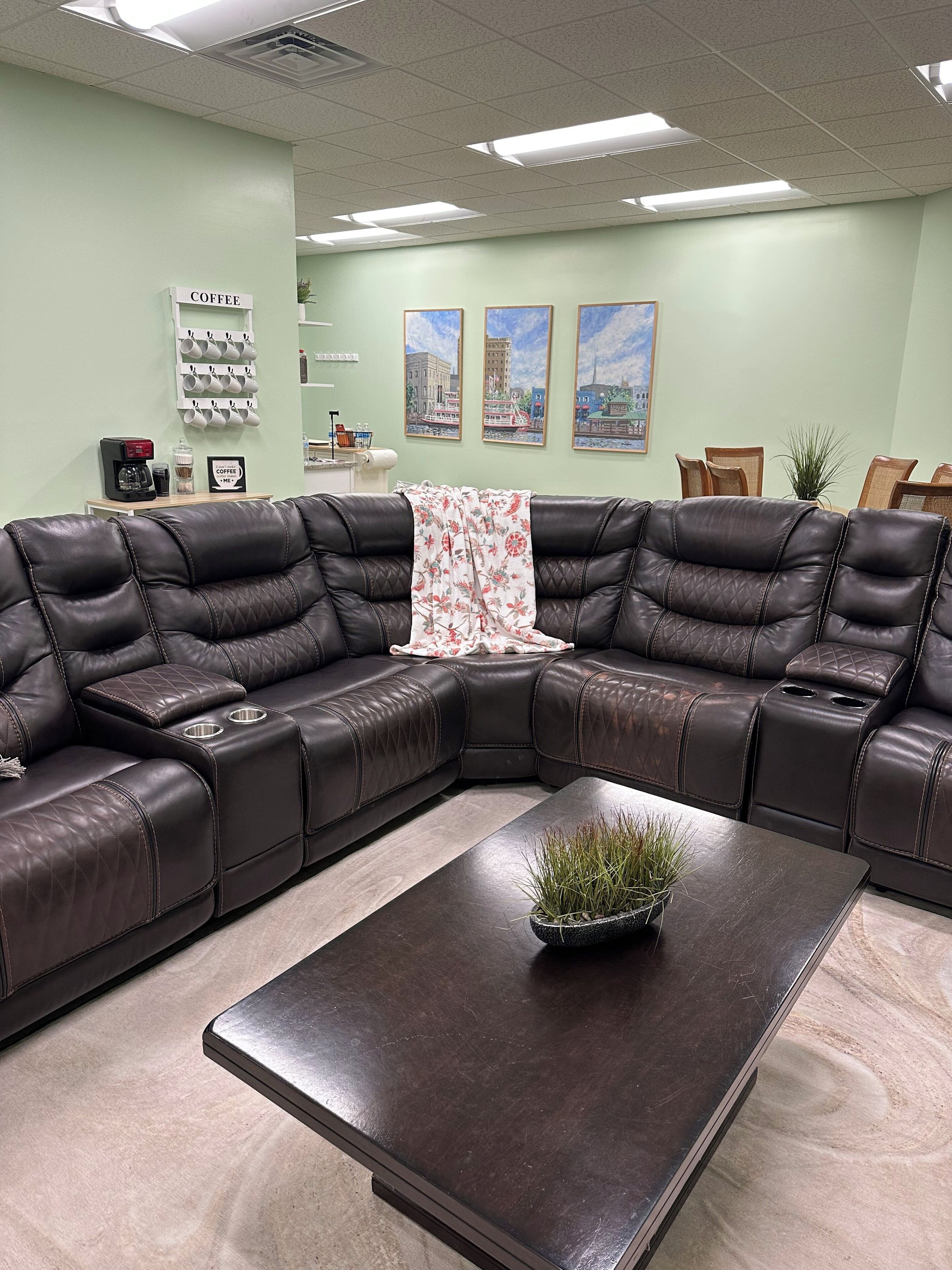 The living room couch with the dinning room, coffee bar, & part of the kitchen. 