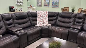The living room couch with the dinning room, coffee bar, & part of the kitchen.