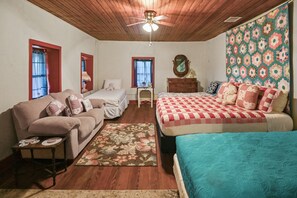 A bedroom with a wooden ceiling, two beds, a dresser, and a mirror. - Stein Haus Ranch 4 Bedroom Home by RedAwning (Castell)