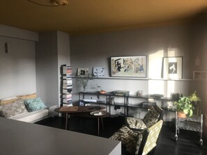Relax in this stylish living room with a sofa, coffee table, and bookshelf.